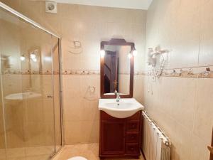 a bathroom with a sink and a shower at Apartamentos Rurales LLeguera in Llanes +18 photos