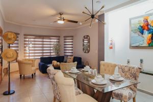 a living room with a table and chairs at Casas Blancas, Planta Baja in Todos Santos +10 photos