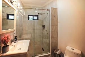 a bathroom with a shower and a sink at Casas Blancas, Planta Baja in Todos Santos