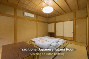 a room with a bed in the middle of it at Kazeya in Takayama