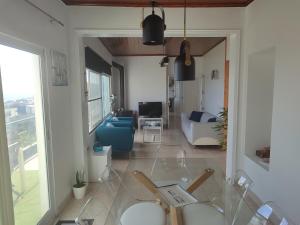 a living room with a glass table and a couch at Sea Bay House in Lagoa