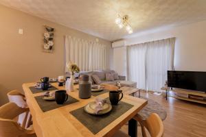 a living room with a table and a couch at ベル高崎 in Takasaki
