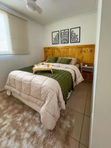 a bedroom with two beds and a table on it at Apê 302 prox ao SESC in Franca