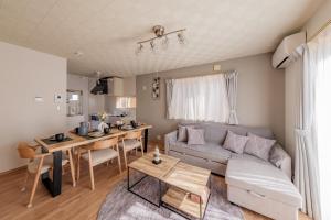 a living room with a couch and a table at ベル高崎 in Takasaki
