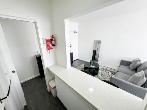 a living room with a couch and a table at Clean Bright Studio Apartment - Walkable Location in Melbourne