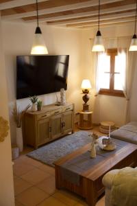 a living room with a large flat screen tv at Finca Ses Eres in Artá