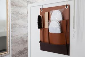 a bathroom door with a brush and a mirror at WITH SEA Nakama in Onna +49 photos