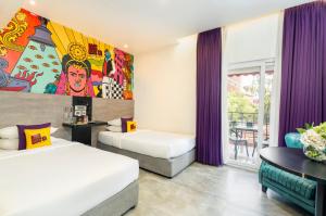 a hotel room with two beds and a painting on the wall at GaasBaasCompany, Thamel, Kathmandu in Kathmandu +151 photos