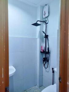 a white bathroom with a toilet and a sink at JAG Homes in Puerto Princesa City