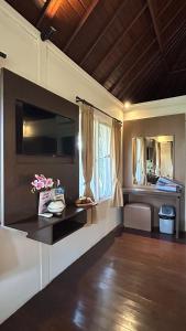 a living room with a table and some windows at Balangan Surf Resort in Jimbaran