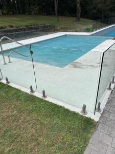 a swimming pool with a reflection in the water at Excelente, Exclusivo Depto en Pucón in Pucón