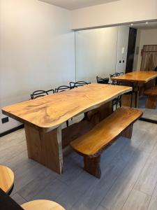 a large wooden table with benches in a room at Excelente, Exclusivo Depto en Pucón in Pucón +12 photos