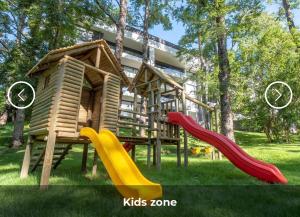 a playground with two slides and a play house at Excelente, Exclusivo Depto en Pucón in Pucón