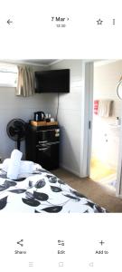 a picture of a bedroom with a bed in a room at Raglan park rest and stay cabins - Private studio in Raglan