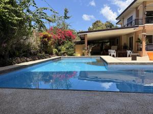 a swimming pool in front of a house at Blue Villa - Entire House with Private Pool in Panglao Island