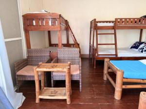 a room with two bunk beds and a table and chairs at Blue Villa - Entire House with Private Pool in Panglao Island
