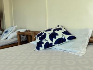 a pillow sitting on top of a bed at Blue Villa - Entire House with Private Pool in Panglao Island