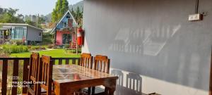 a wooden table and chairs on a porch at เล่าจู in Ban Na Yang