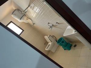 an overhead view of a bathroom with a toilet and sink at Hotel Dubeyinn in Katra +2 photos