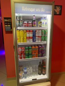 a refrigerator filled with lots of different types of drinks at Hotel Lalique in São Paulo