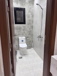 a bathroom with a shower and a toilet and a sink at دار مسك الفندقية in Medina +2 photos