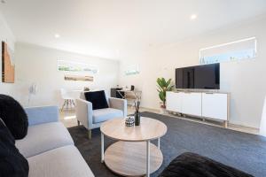 a living room with a couch and a tv at Studio 17 Private Standalone Studio in Greenhithe North Shore in Auckland