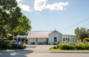 a white building with a sign in front of it at Studio 17 Private Standalone Studio in Greenhithe North Shore in Auckland +2 photos