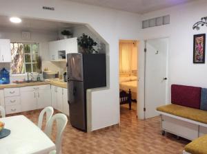 a kitchen with a refrigerator in the middle of a room at Casa D' Linda in San Andrés