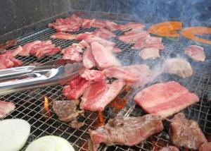 a bunch of meat on a grill with some onions at 森のハナ in Chichibu