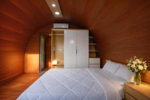 a bedroom with a large bed with a wooden wall at New Sky Homestay in Chợ Phước Hải