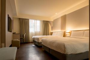 a hotel room with two beds and a window at VIP Hotel in Taipei +23 photos