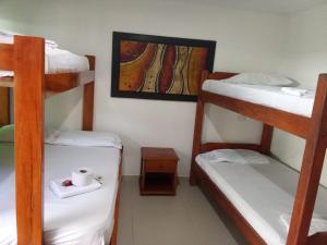 a room with three bunk beds and a picture on the wall at Alojamiento PLAYA DORADA Coveñas in Coveñas