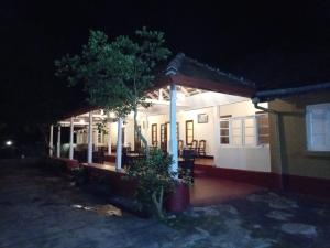 a house at night with a tree in front of it at Thanayama Deniyaya in Deniyaya