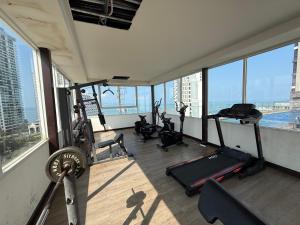 a gym with several exercise equipment in a building at 2 BEDrooms with coffee machine,gym,rooftop pool in North Pattaya