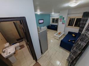 a bathroom with a couch and a sink in a room at Avrio Red Sea in Hurghada +44 photos