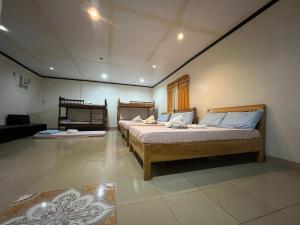 a bedroom with two beds in a room at Harmony Place at Hillside in Puerto Princesa City