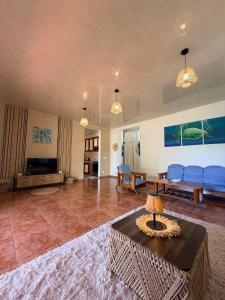 a large living room with a couch and a table at Fare Hinenao in Tevaitoa