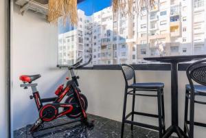 a bike parked next to a table and two chairs at Blue Chic Luxury Studio with Pool and AC in Agadir