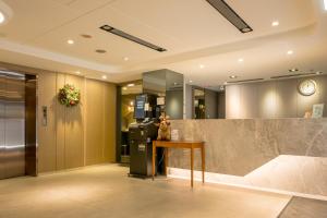 an office lobby with a desk and a refrigerator at VIP Hotel in Taipei