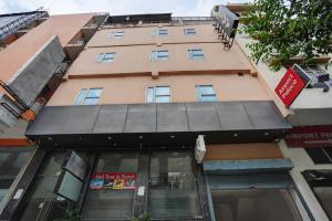 a building with a black awning in front of it at Hotel IBY in New Delhi