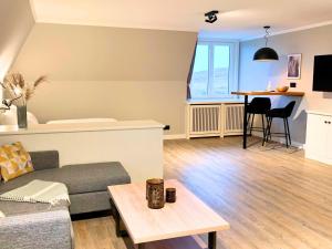 a living room with a couch and a table at Kliffsand-73 in Kampen