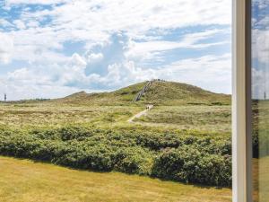 a view of a hill from a window at Kliffsand-73 in Kampen