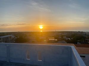 a sunset from the roof of a building at Hospedaje Zerimar in Puerto Baquerizo Moreno +7 photos