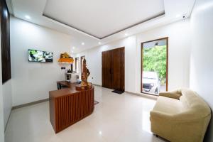 a living room with a couch and a table at Dekade Living in Denpasar
