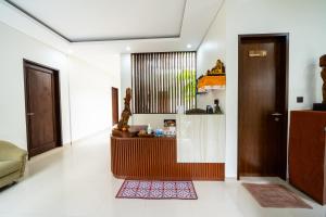 a living room with a reception desk in a house at Dekade Living in Denpasar