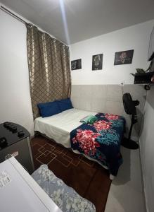 a small room with two beds and a desk at Kitnet Dream House 2 in Bayeux