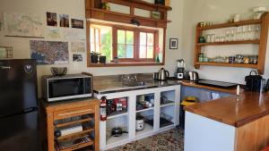 a kitchen with a sink and a tv on a counter at Twin Kauri's 94 in Cambridge