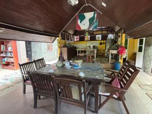 a dining room table and chairs with a table and a kitchen at Gio Private Villa - Langkawi in Langkawi Intl