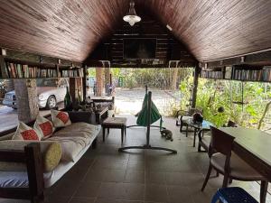 a living room with a couch and a tv at Gio Private Villa - Langkawi in Langkawi Intl