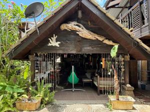 a wooden house with a roof with a table at Gio Private Villa - Langkawi in Langkawi Intl